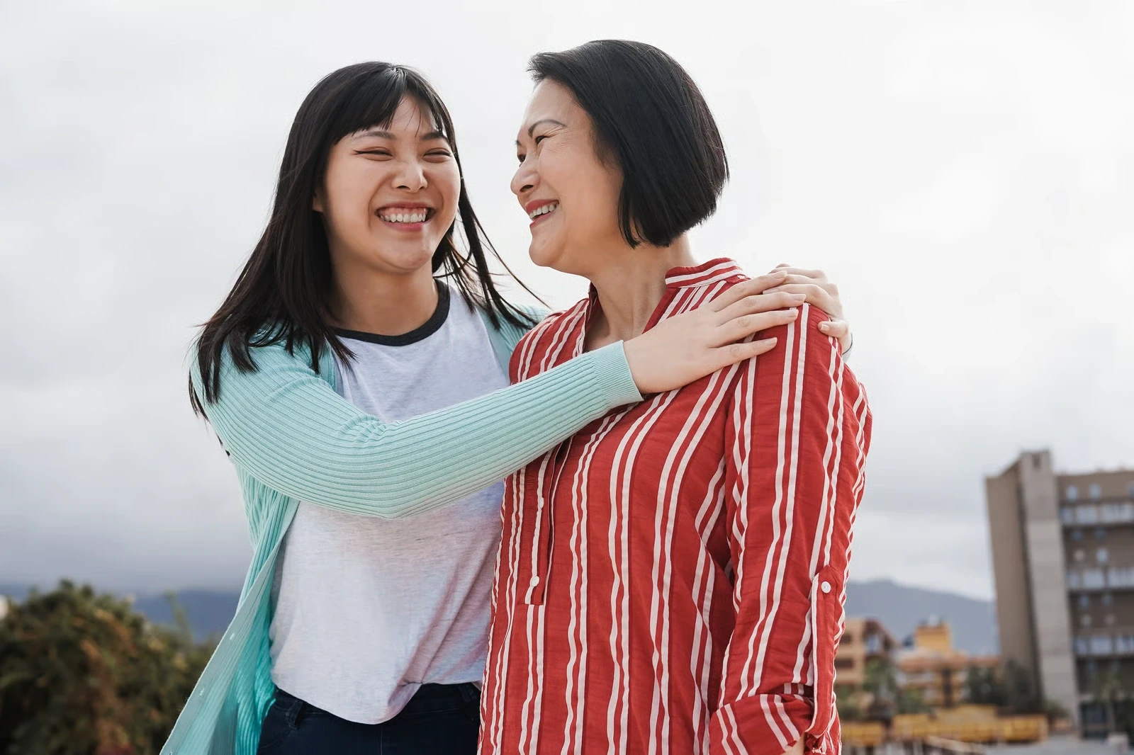 Two women laughing together outdoors