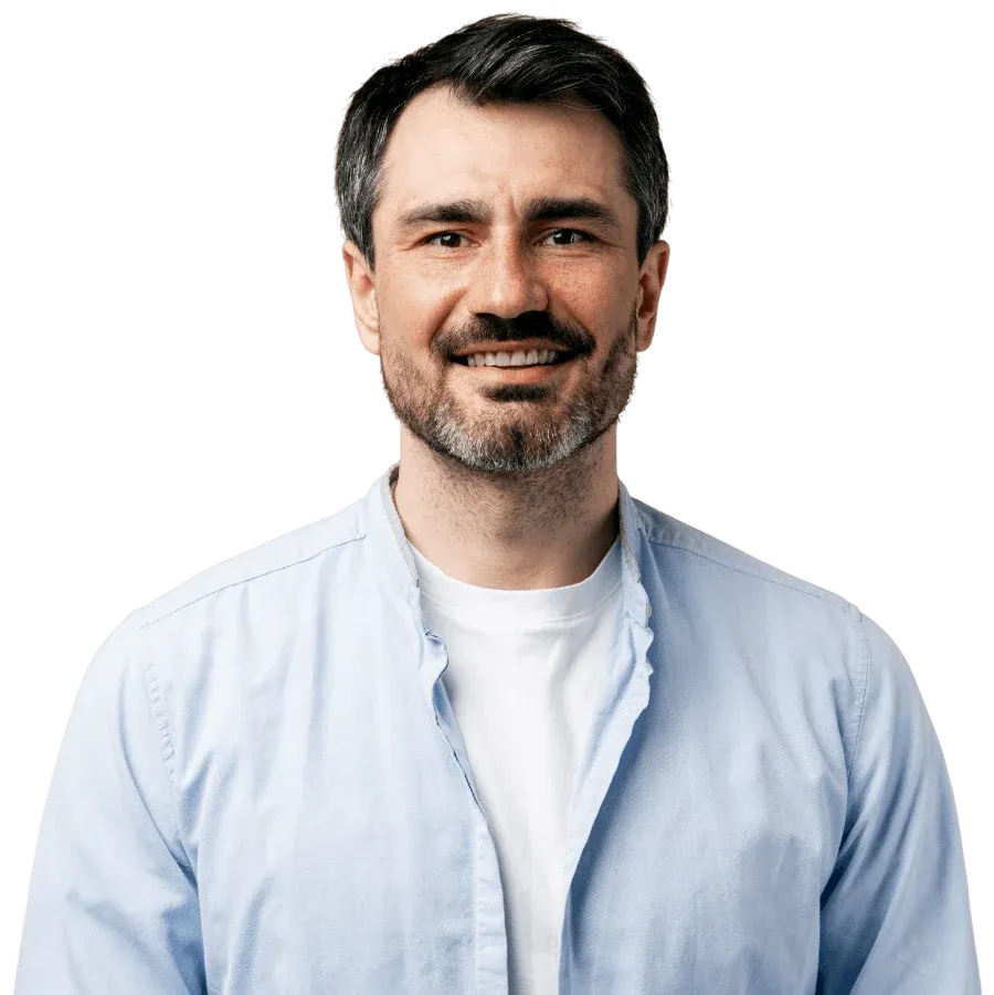 Man in a light blue shirt smiling, ready to join a video session