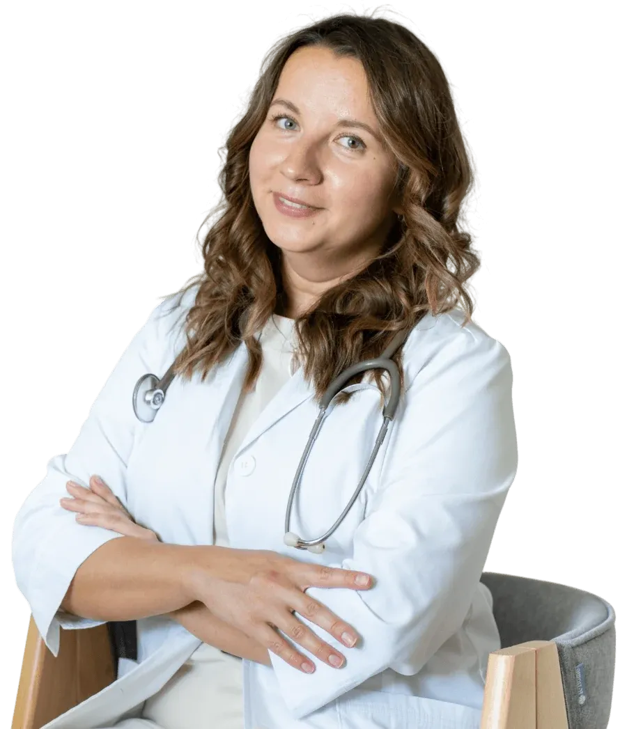 Illustrative photo of a smiling woman seated with her arms folded